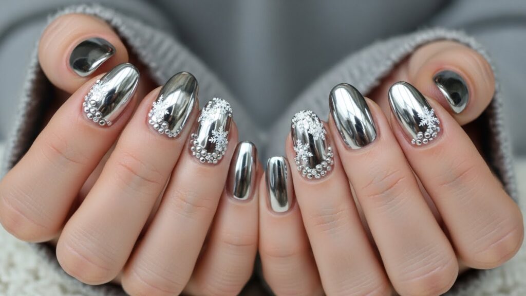 Silver metallic Christmas nails, chrome effect, stylish winter look.