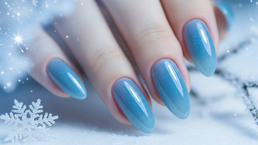 Frosted icy blue gel nails with snowy background.