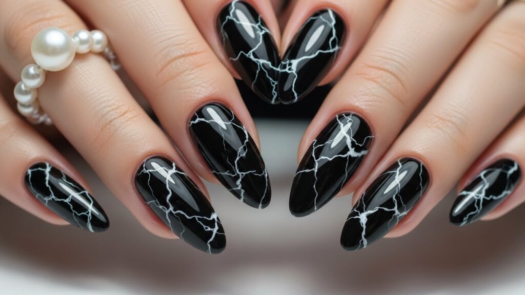 Black marble nails with white marble lines.
