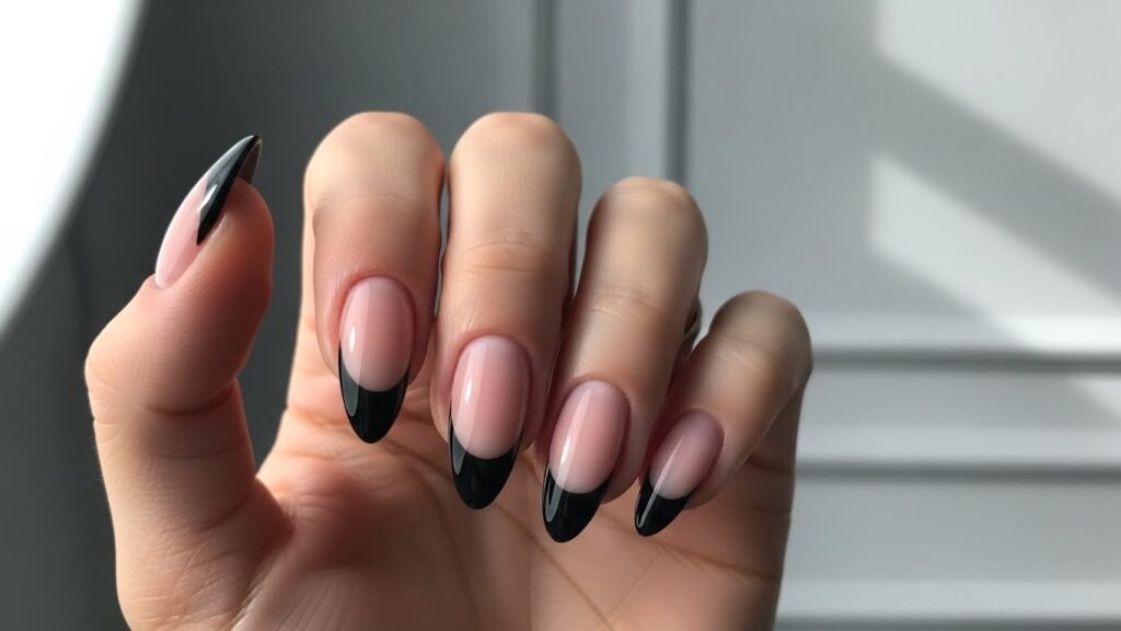 Black French tip nails with bold modern style.