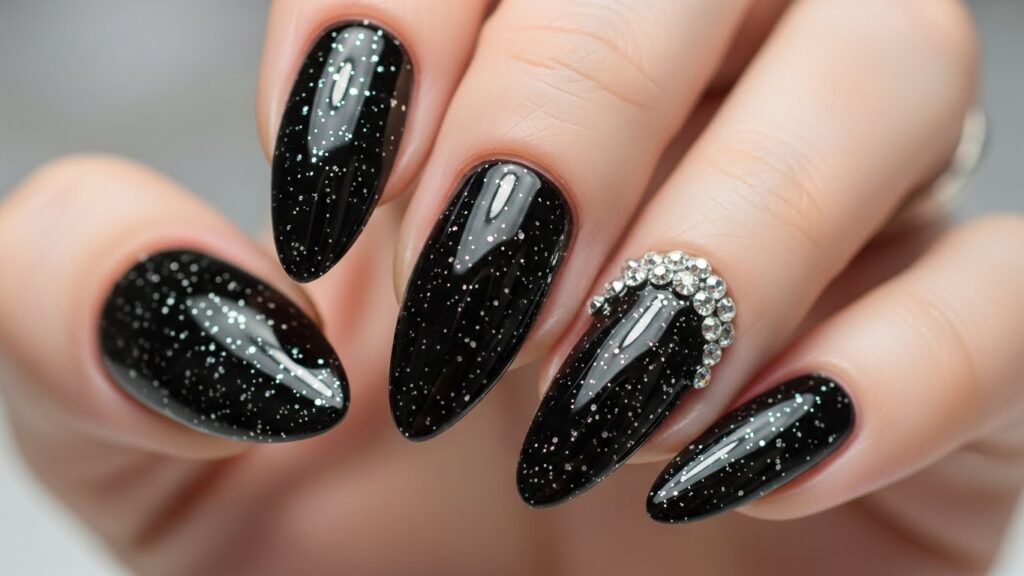 Black nails decorated with rhinestones