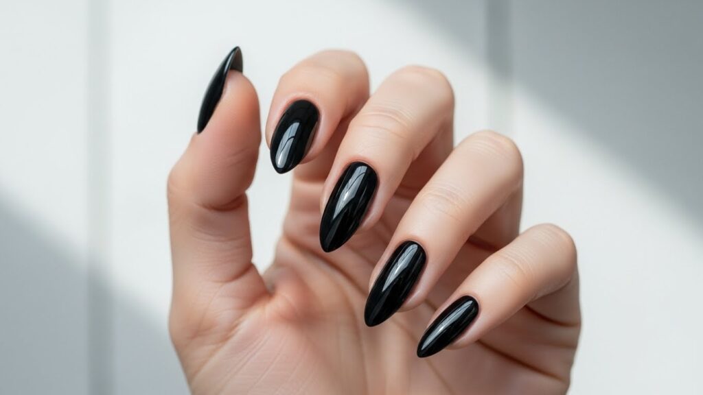 Glossy black almond-shaped nails